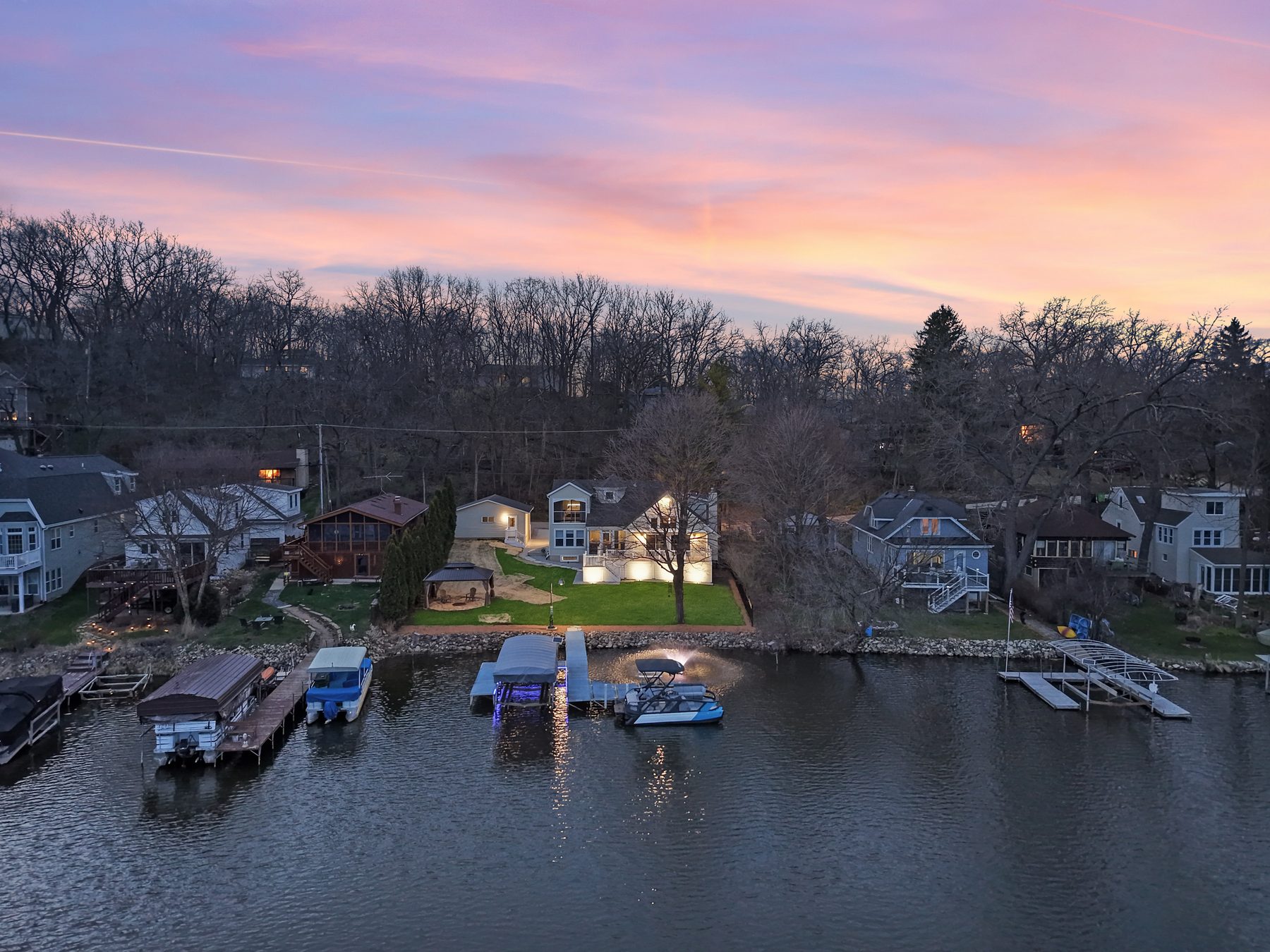 Aerial photo of a lakefront estate at sunset